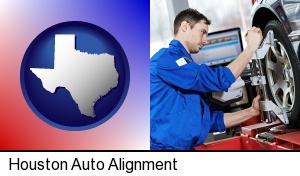 a mechanic adjusting a wheel alignment machine clamp in Houston, TX