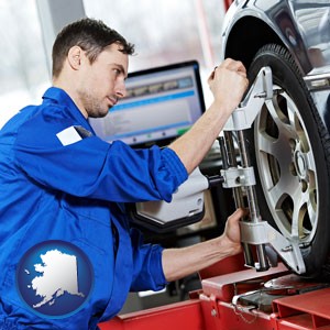 a mechanic adjusting a wheel alignment machine clamp - with Alaska icon
