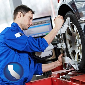 a mechanic adjusting a wheel alignment machine clamp - with California icon