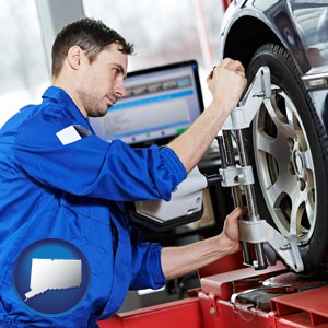 a mechanic adjusting a wheel alignment machine clamp - with Connecticut icon