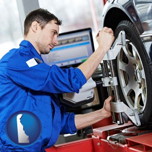 a mechanic adjusting a wheel alignment machine clamp - with Delaware icon