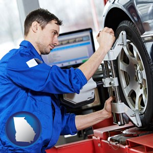a mechanic adjusting a wheel alignment machine clamp - with Georgia icon