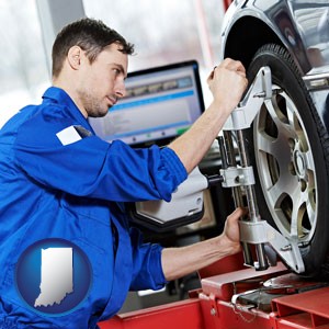 a mechanic adjusting a wheel alignment machine clamp - with Indiana icon