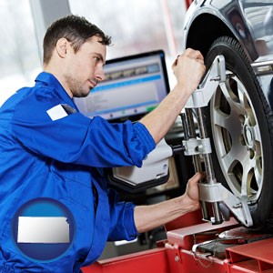 a mechanic adjusting a wheel alignment machine clamp - with Kansas icon