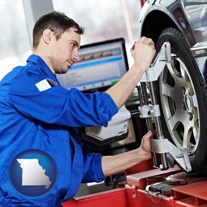 a mechanic adjusting a wheel alignment machine clamp - with Missouri icon