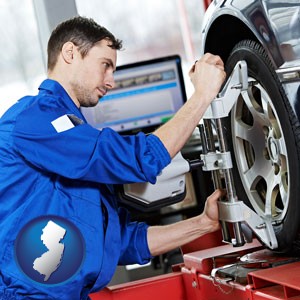 a mechanic adjusting a wheel alignment machine clamp - with New Jersey icon